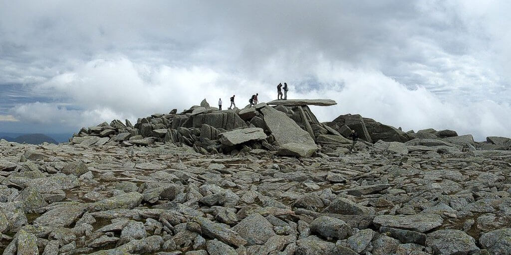 Hikers on the Cantilever Stone, Glyder Fach, Glyderau, Welsh Mountains.