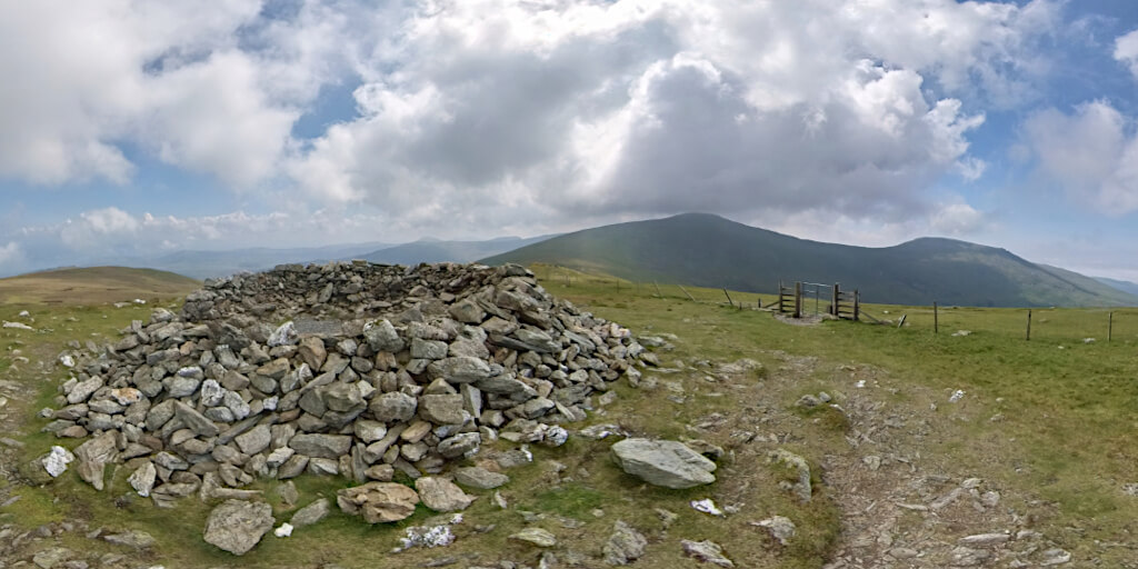 The Bronze Age cairn on Drum (770 m) with Foel-fras (942 m) and Llwytmor (849 m) in the background, Welsh Mountains.
